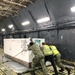 Reserve and active-duty Sailors assigned to Norfolk Navy-operated Air Mobility Command Air Terminal load palettes onto a C-5 military cargo plane