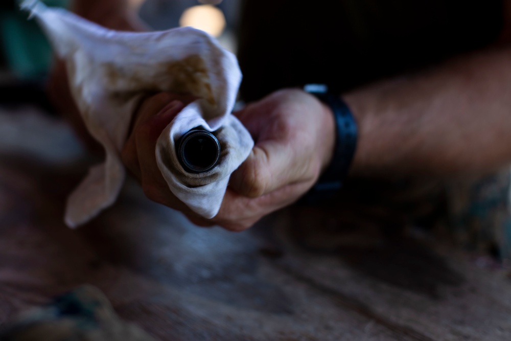 U.S. Marines clean rifles to prepare for upcoming exercises