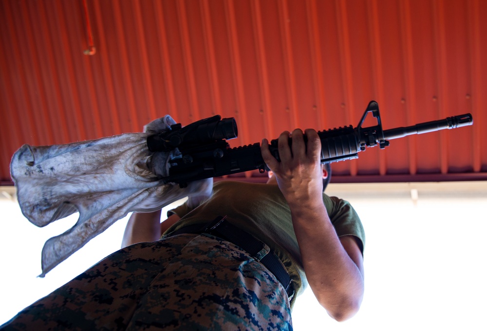 U.S. Marines clean rifles to prepare for upcoming exercises