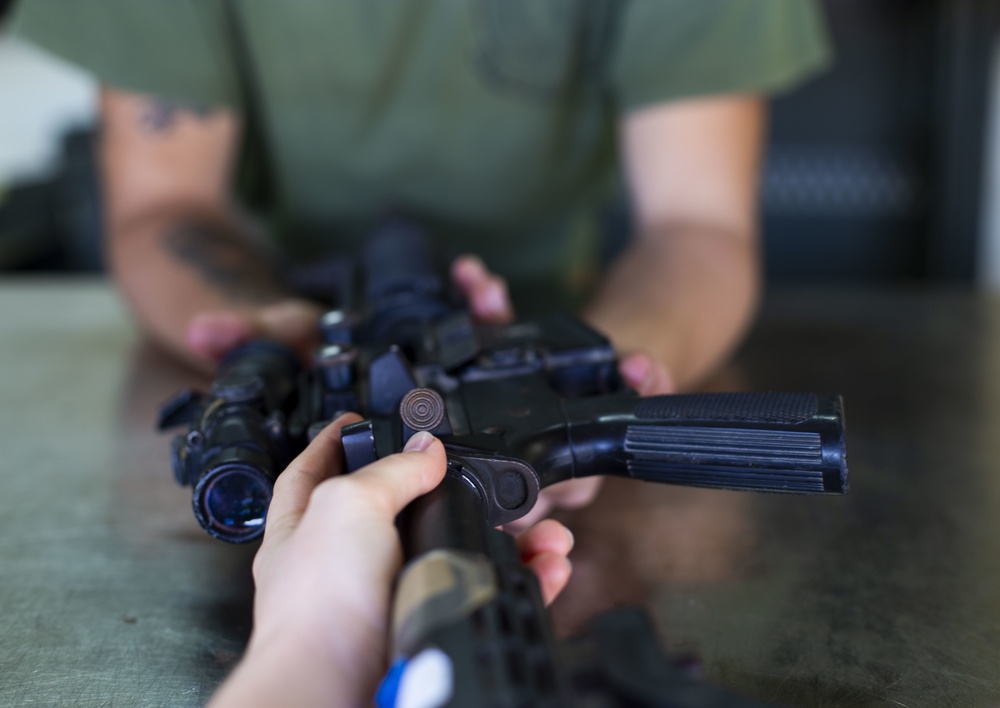 U.S. Marines clean rifles to prepare for upcoming exercises