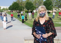 Giles poses with retirement flag
