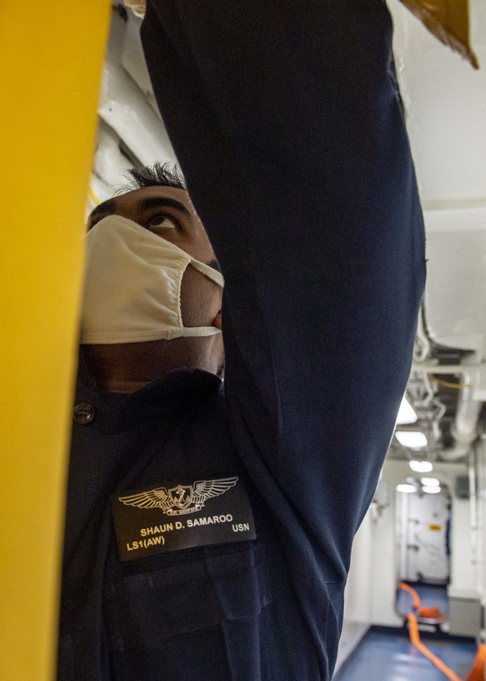 Sailor Hangs Smoke Containment Curtain