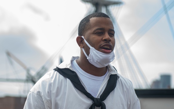 Retail Specialist 1st Class Kenneth Johnson gives a tour for Facebook Live