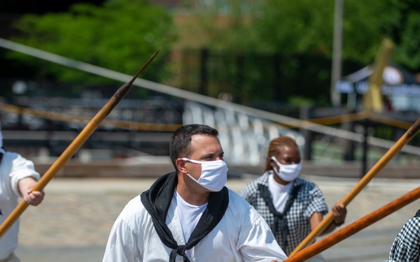 Sailors demonstrate pike drills for Facebook Live