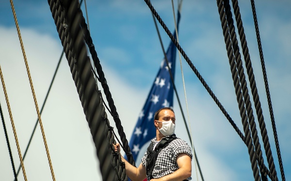 Seaman Nathaniel Roth climbs aloft for the fourth of July Facebook Live celebration