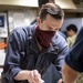 Sailor Cuts Cake During Pride Celebration