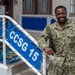 IS2 Joshua James stands in front of the entrance of Commander, Carrier Strike Group (CCSG) 15