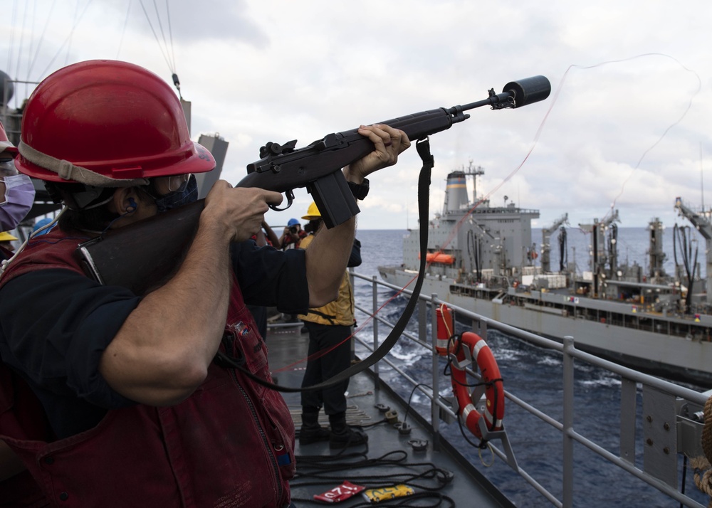 Sailor Fires Shot Line During Replenishtment-at-Sea