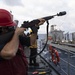 Sailor Fires Shot Line During Replenishtment-at-Sea