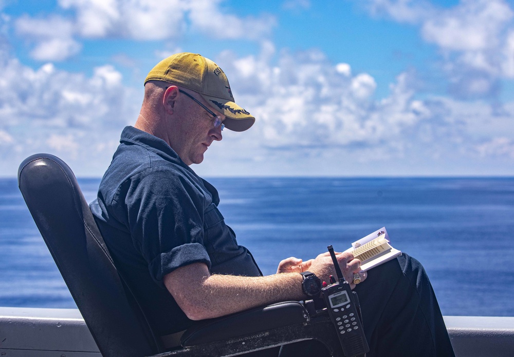 USS New York XO reads on the bridge wing