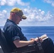 USS New York XO reads on the bridge wing