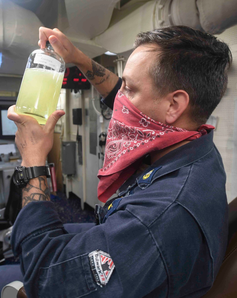 Sailor inspects fuel sample