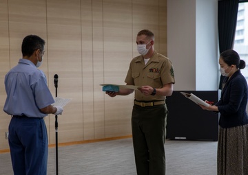 MCAS Iwakuni's Staff Sgt. York recieves a letter of appreciation from the city