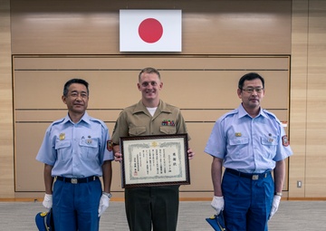 MCAS Iwakuni's Staff Sgt. York recieves a letter of appreciation from the city