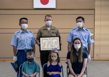 MCAS Iwakuni's Staff Sgt. York recieves a letter of appreciation from the city