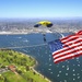 Navy Parachute Team parades the U.S. flag during Independence Day jump