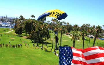 Navy Parachute Team parades the U.S. flag during Independence Day jump