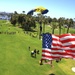 Navy Parachute Team parades the U.S. flag during Independence Day jump