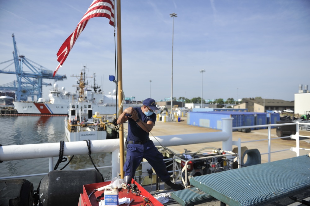 Inland Buoy Tender Frank Drew crew members work to maintain ship's readiness in Portsmouth, VA