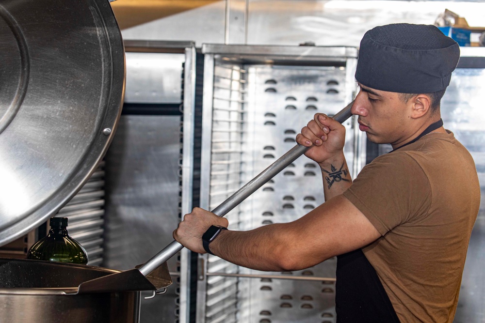 Sailors clean the galley