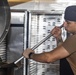 Sailors clean the galley