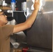 Sailors clean the galley