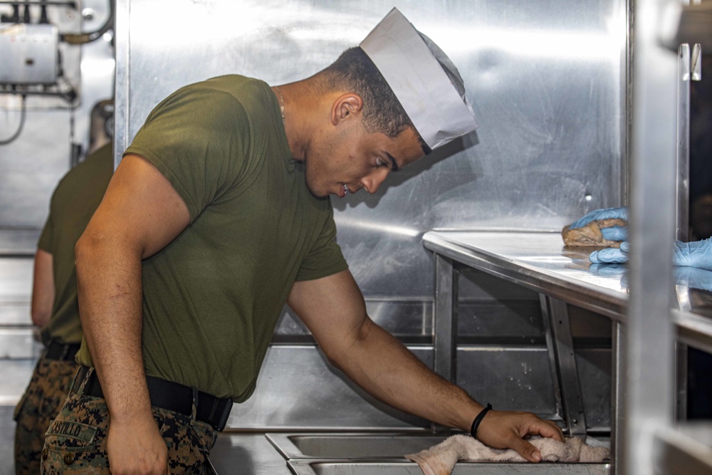 Sailors clean the galley