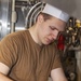 Sailors clean the galley