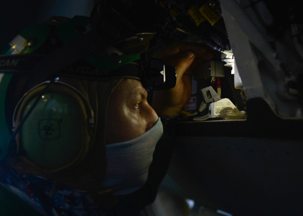 U.S. Navy Sailors Conduct Maintenance on Fighter Jet