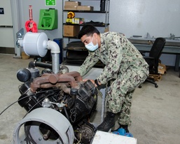 ABE2 Ivan Moreno inspects E-28 Emergency Arresting Gear component
