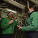 U.S. Navy Sailors Inspect Fighter Pilot Equipment