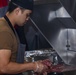 Sailors work in the galley aboard the New York