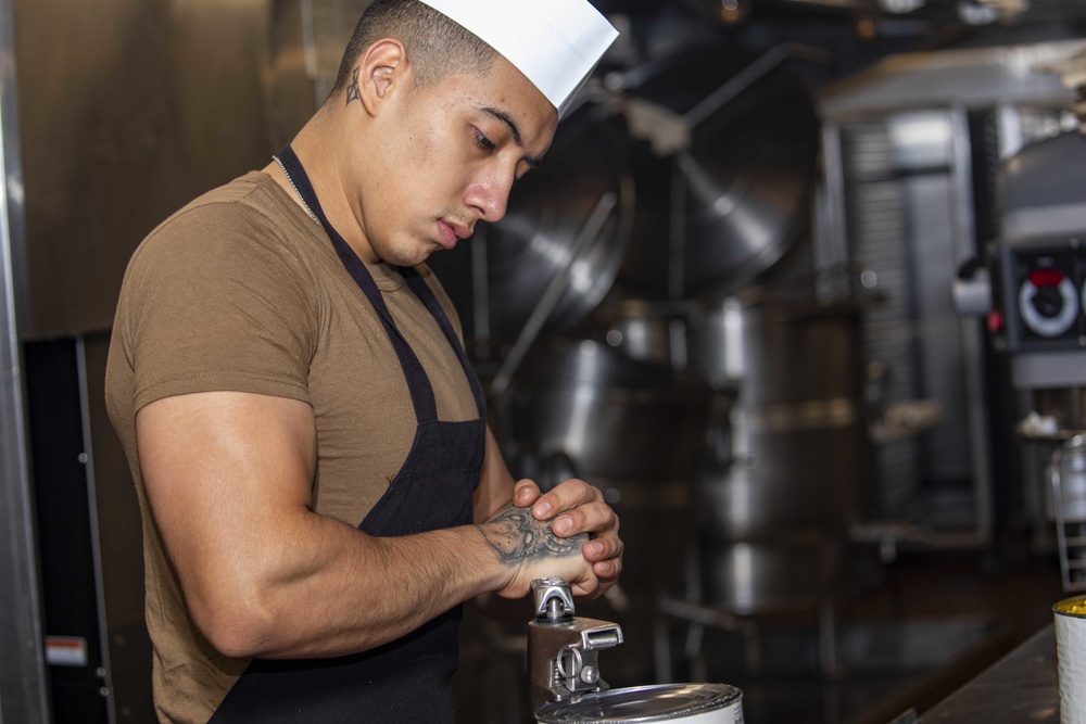 Sailors work in the galley aboard the New York