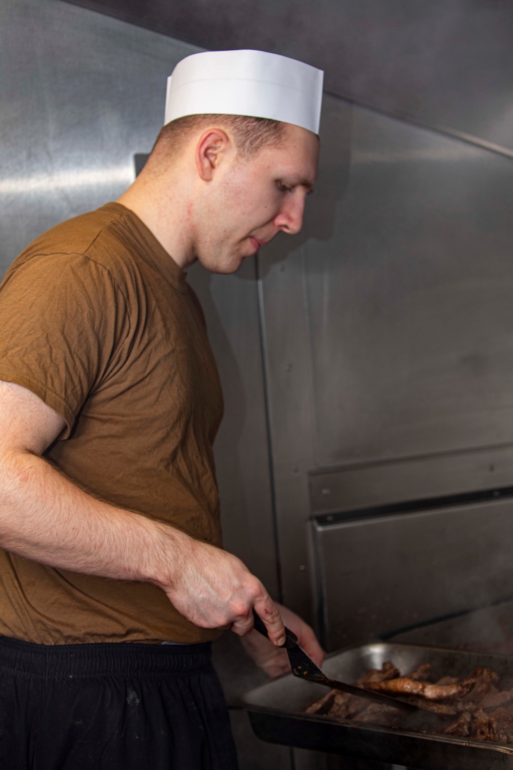 Sailors work in the galley aboard the New York