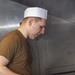 Sailors work in the galley aboard the New York