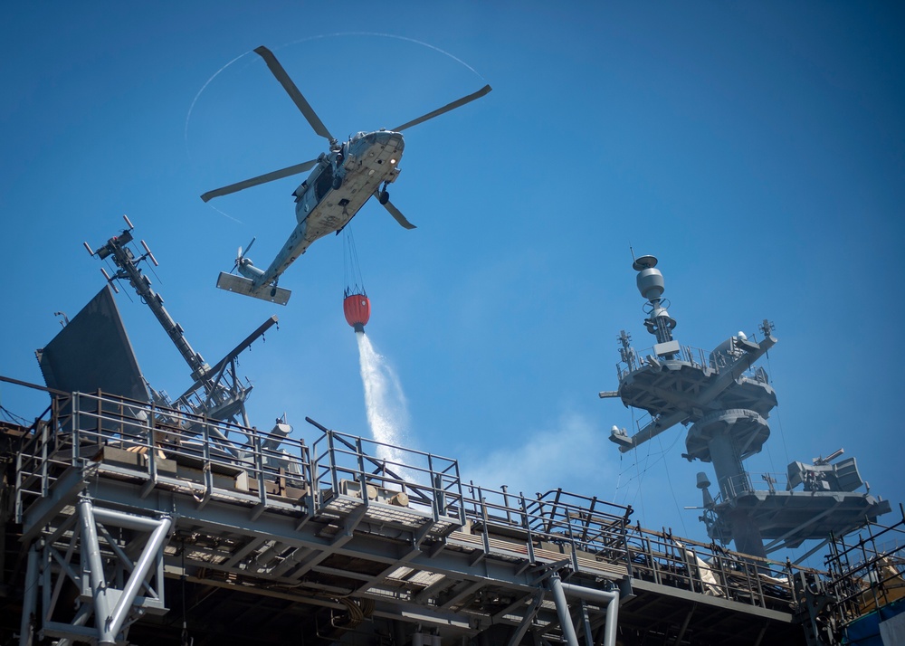 Sailors and Federal San Diego Firefighters fight fire aboard USS Bonhomme Richard