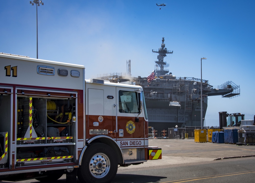Sailors and Federal San Diego Firefighters fight fire aboard USS Bonhomme Richard