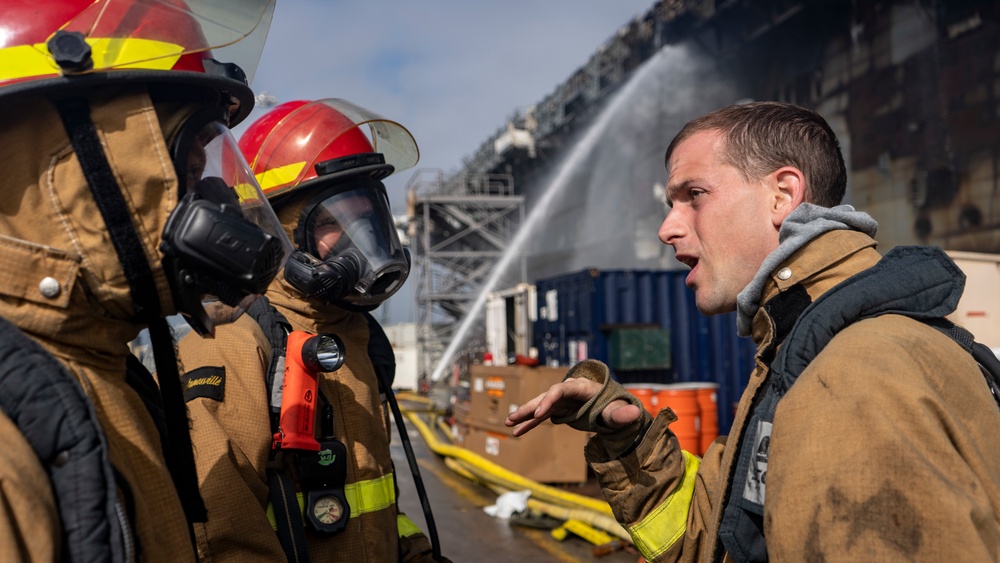 Sailors and Federal San Diego Firefighters fight fire aboard USS Bonhomme Richard