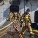 Sailors and Federal San Diego Firefighters fight fire aboard USS Bonhomme Richard