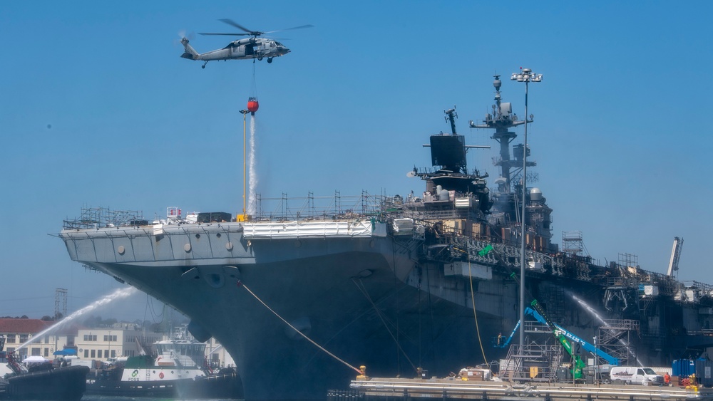 Sailors and federal San Diego firefighters fight fire aboard USS Bonhomme Richard