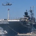 Sailors and federal San Diego firefighters fight fire aboard USS Bonhomme Richard