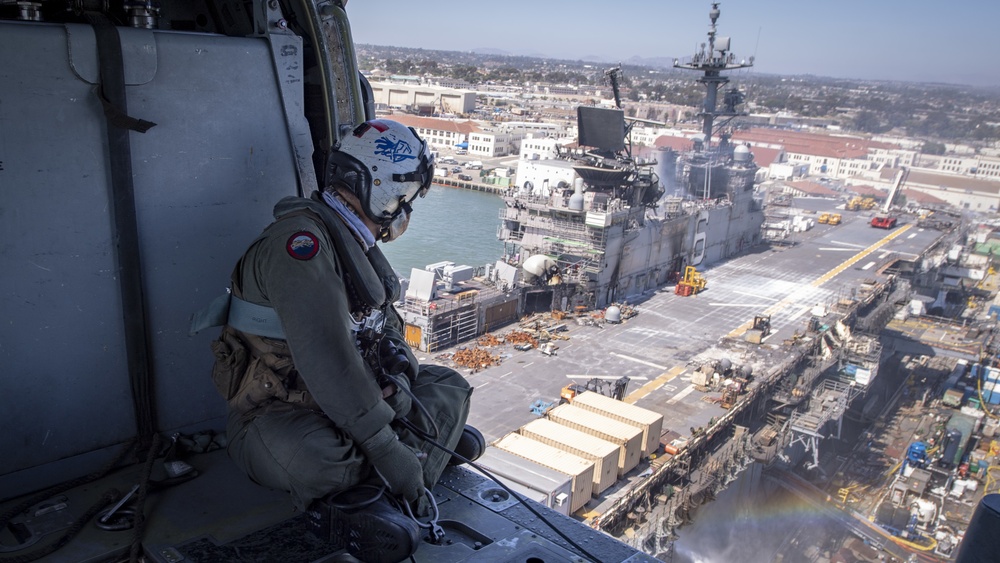 Sailors and federal San Diego firefighters fight fire aboard USS Bonhomme Richard