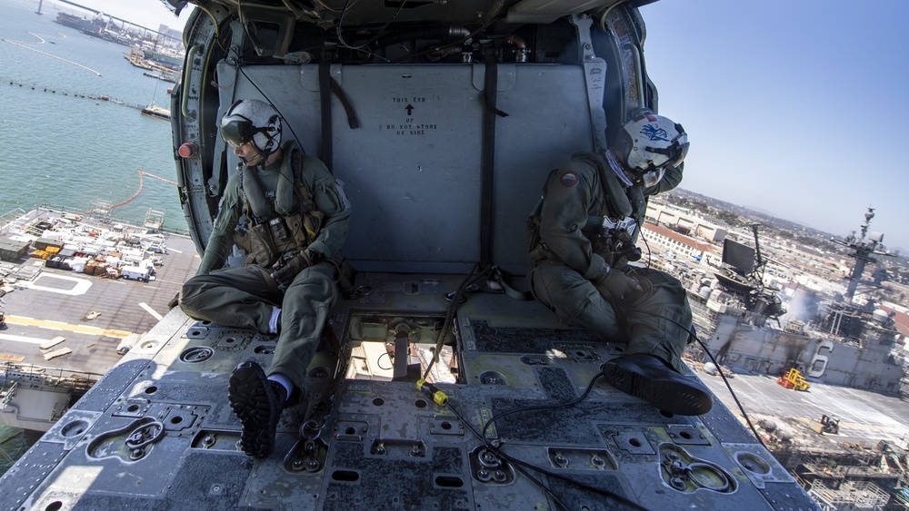 Sailors and federal San Diego firefighters fight fire aboard USS Bonhomme Richard