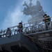 Sailors and federal San Diego firefighters fight fire aboard USS Bonhomme Richard