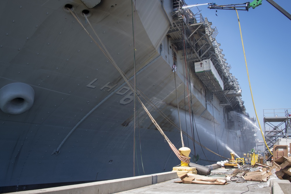 Sailors and federal San Diego firefighters fight fire aboard USS Bonhomme Richard