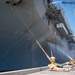 Sailors and federal San Diego firefighters fight fire aboard USS Bonhomme Richard