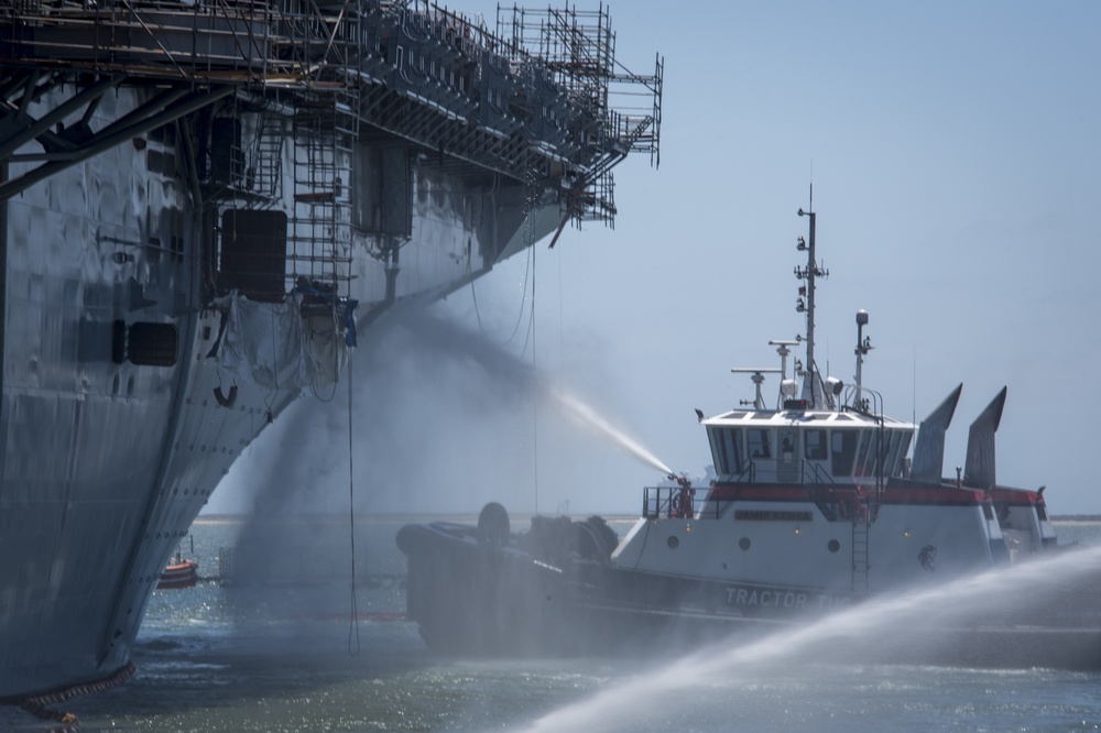 Sailors and federal San Diego firefighters fight fire aboard USS Bonhomme Richard