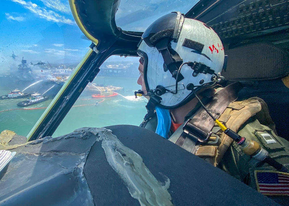 Sailors and federal San Diego firefighters fight fire aboard USS Bonhomme Richard