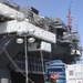 Sailors and federal San Diego firefighters fight fire aboard USS Bonhomme Richard