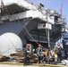 Sailors and federal San Diego firefighters fight fire aboard USS Bonhomme Richard